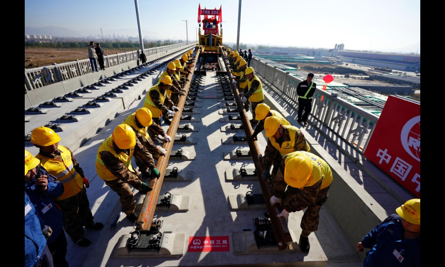 京张高铁是国家重点建设项目，是2022年北京冬奥会的重要交通保障线。京张高铁全长174公里，建成后，乘高铁从北京到张家口的时间将缩短到50分钟，对于助力奥运、促进京津冀一体化发展、连接西部都具有十分重要的战略意义。图为11月1日，在京张高铁河北怀来段铺轨现场，中铁三局的工人铺下京张高铁全线第一节轨排。（新华社记者 杨世尧 摄）