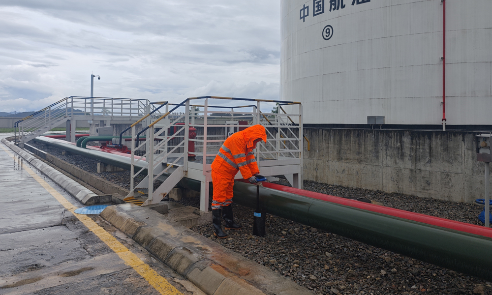 中国航油贵州分公司业务油库值班人员在暴雨天巡查储油罐区。