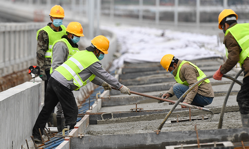 春节期间，5500余名参与建设我国首条民营控股高铁——杭绍台铁路的员工坚守岗位就地过年，工人们利用晴好天气奋战在工地上，稳步推进工程进度。图为2月17日，杭绍台铁路中铁三局参建工人在位于浙江绍兴上虞区境内的绍兴特大桥进行轨道底板浇筑施工。（新华社记者 黄宗治 摄）