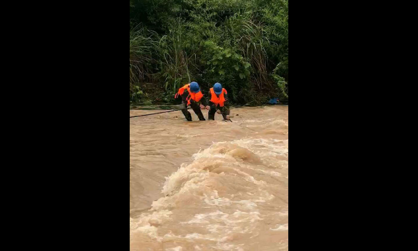 图为6月9日，福建清流县供电公司抢修人员将倒杆后被掩埋的10千伏各溪线导线清理出来。
