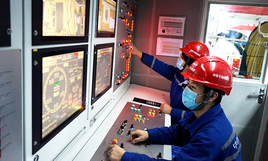 图为技术员在操控室驾驶盾构机。